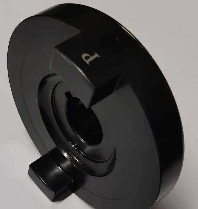 A black metal spacer and coupler component with a central circular opening and a 'P' marking, displayed on a white background.